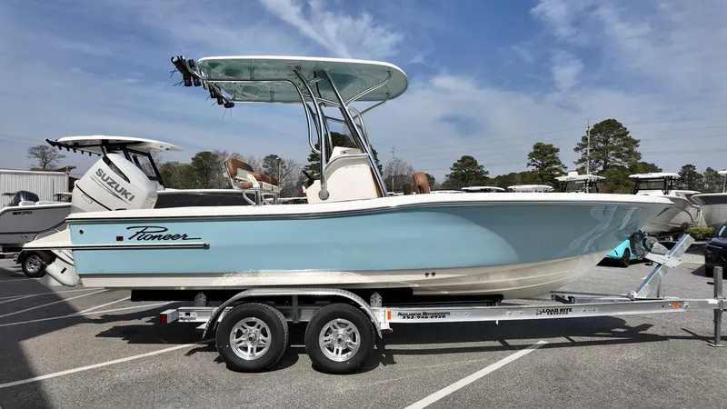 Slide: The Image of 2025 Pioneer 220 Bay Sport boat on trailer, side view, in parking lot. - 3