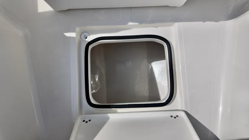 Slide: The Image of Storage compartment on 2025 Pioneer 220 Bay Sport boat, open lid view. - 8
