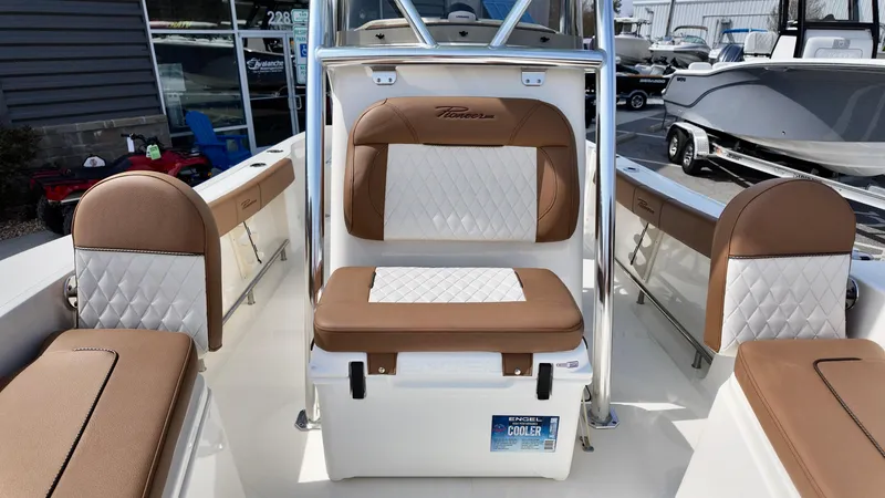 Slide: The Image of 2025 Pioneer 220 Bay Sport boat interior with brown and white cushioned seating. - 9