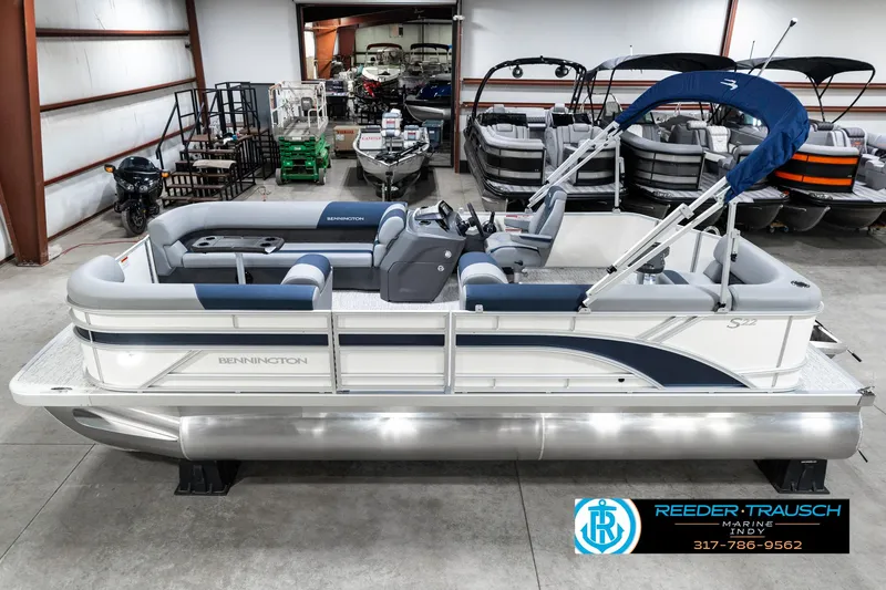 The Image of 2025 Bennington 22 SLS pontoon boat in showroom, featuring sleek design and blue accents. - 0