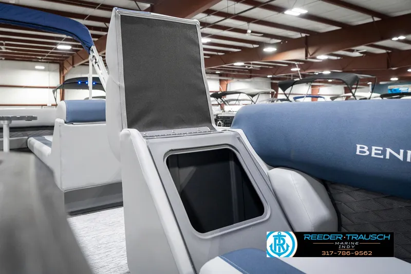 Slide: The Image of 2025 Bennington 22 SLS boat interior with storage compartment open, displayed in a showroom. - 24