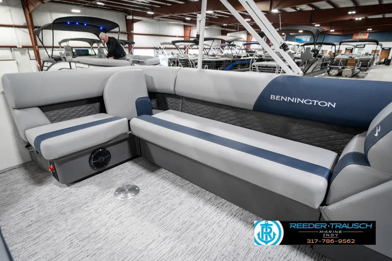 Slide: The Image of 2025 Bennington 22 SLS pontoon boat interior with gray seating in showroom. - 29