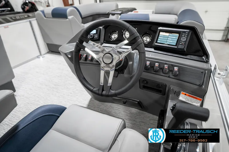 Slide: The Image of 2025 Bennington 22 SLS boat interior with steering wheel and dashboard controls. - 30