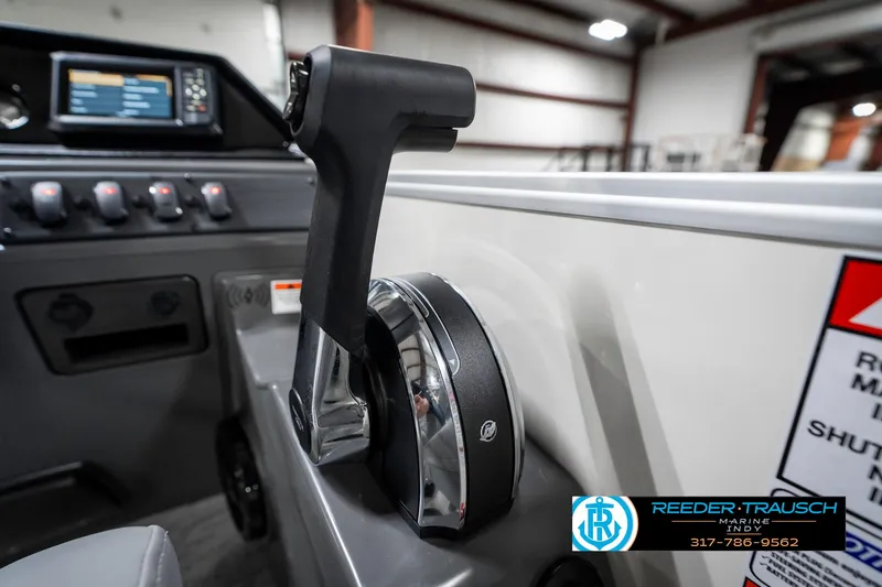 Slide: The Image of Throttle control of 2025 Bennington 22 SLS boat in a showroom setting. - 38