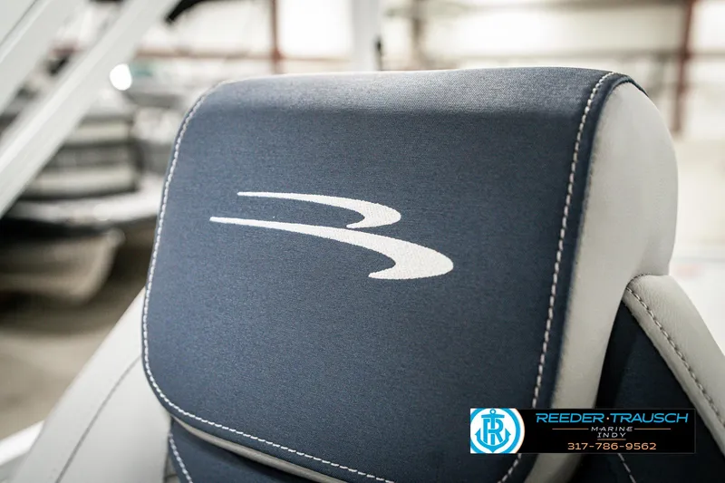 Slide: The Image of 2025 Bennington 22 SLS boat seat with logo, featuring blue and white upholstery. - 43
