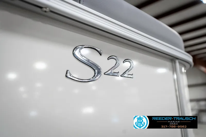 Slide: The Image of 2025 Bennington 22 SLS boat with "S22" emblem in a showroom setting. - 49