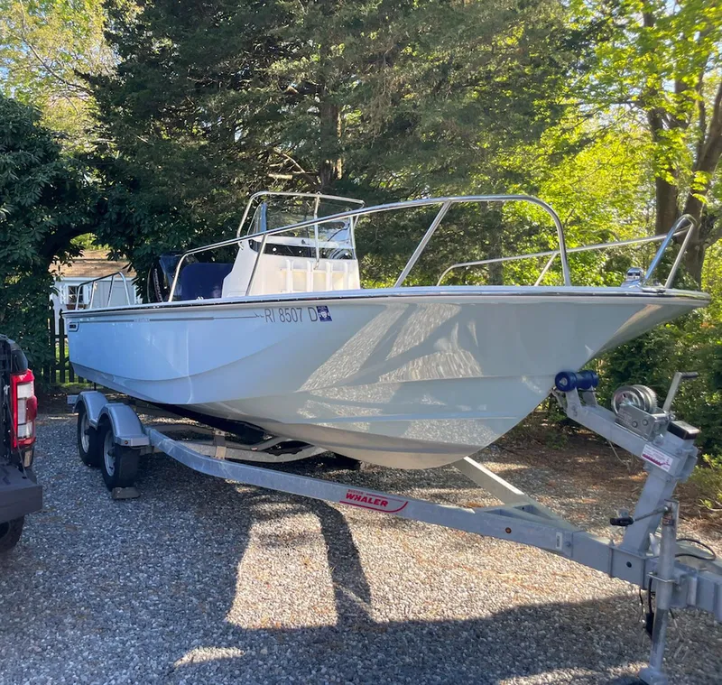 Slide: The Image of 2020 Boston Whaler 190 Montauk boat on trailer, parked outdoors. - 2