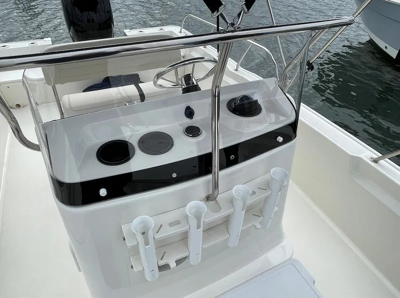 Slide: The Image of 2020 Boston Whaler 190 Montauk boat console with steering wheel and rod holders. - 5
