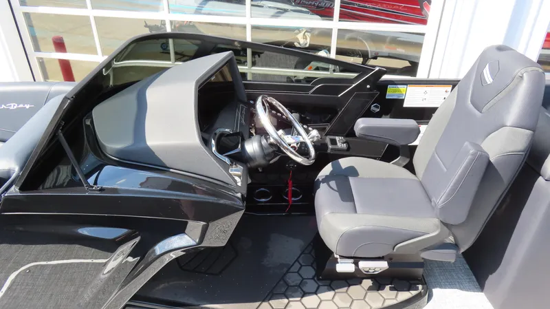 Slide: The Image of 2025 South Bay 25 Sport CR9 3 boat interior with sleek black dashboard and comfortable seating. - 5