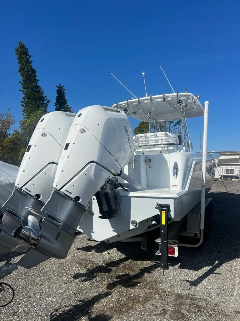 Slide: The Image of 2024 Contender 35 ST boat with dual outboard engines, parked on a trailer. - 3