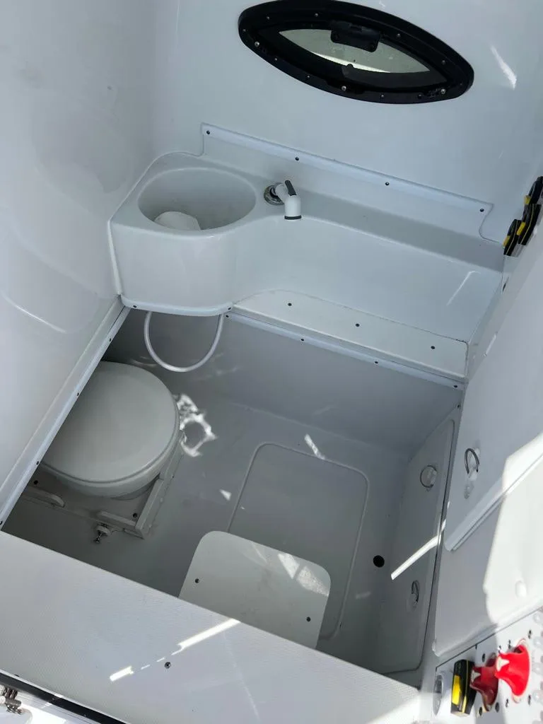 Slide: The Image of 2024 Contender 35 ST boat interior bathroom with toilet and sink. - 7