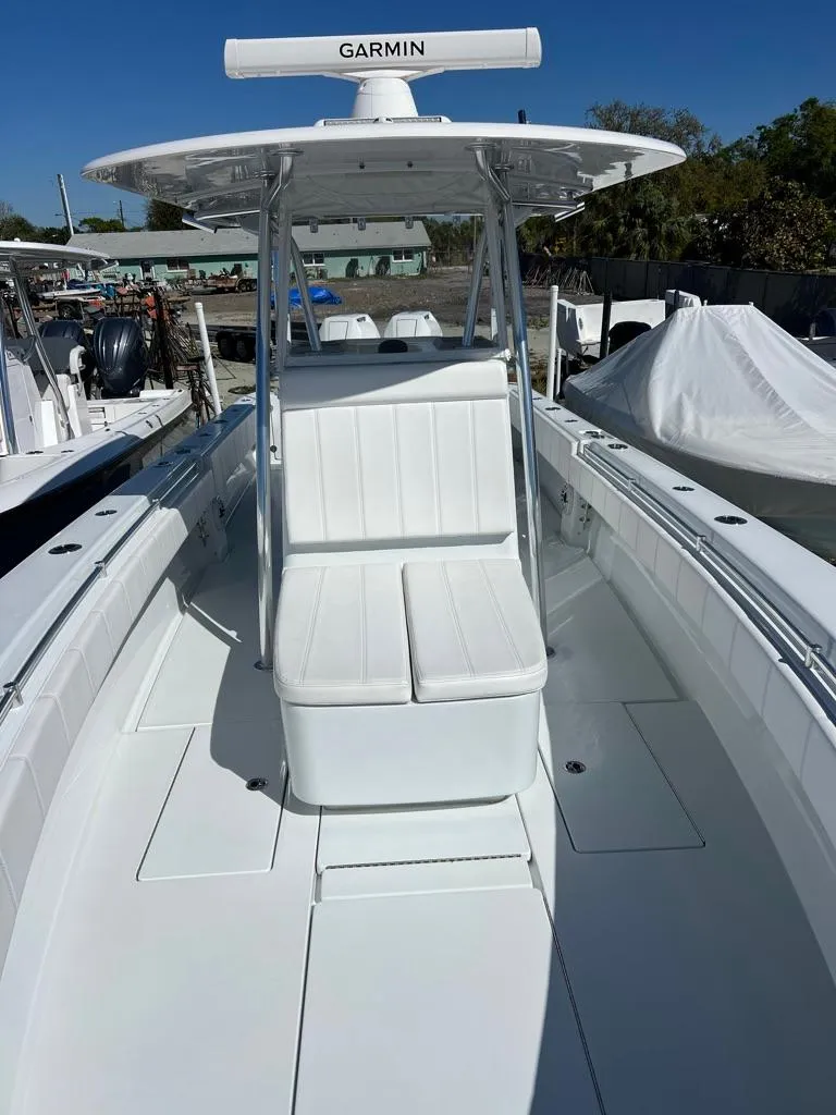 Slide: The Image of 2024 Contender 35 ST boat with Garmin equipment, featuring sleek white seating and spacious deck. - 9