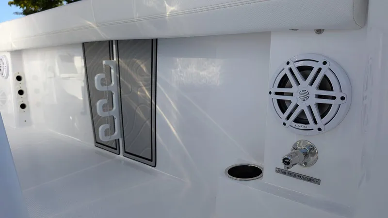 Slide: The Image of 2025 Wellcraft 243 Fisherman boat interior with speaker and rod holders. - 12