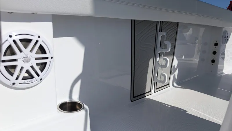 Slide: The Image of 2025 Wellcraft 243 Fisherman boat interior with speaker and cup holder. - 13