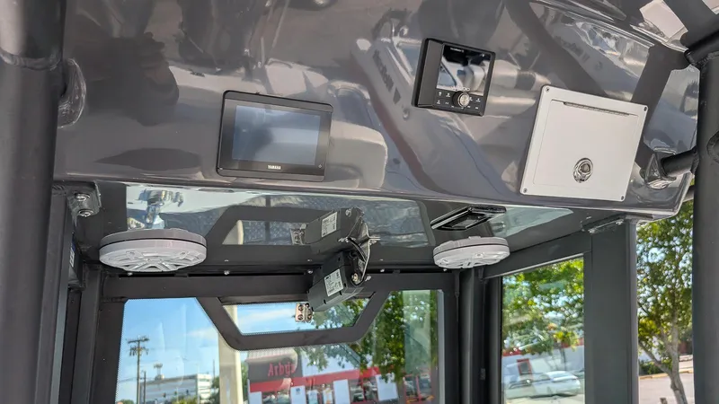 Slide: The Image of Interior view of 2025 Wellcraft 243 Fisherman boat's control panel and electronics. - 16