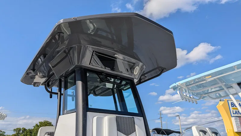 Slide: The Image of 2025 Wellcraft 243 Fisherman boat with sleek design under a clear blue sky. - 24