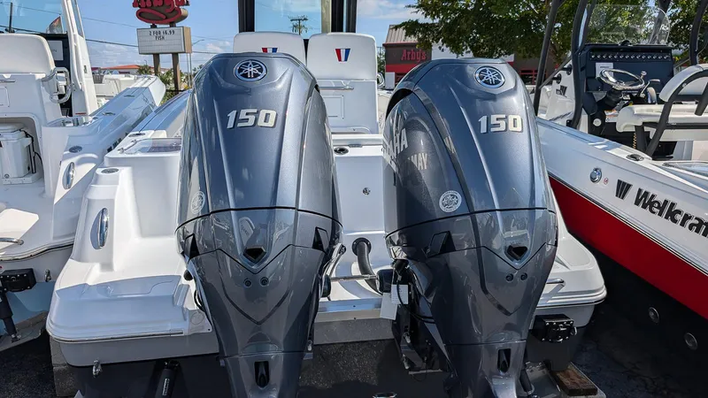 Slide: The Image of 2025 Wellcraft 243 Fisherman boat with dual 150 horsepower engines, rear view. - 3