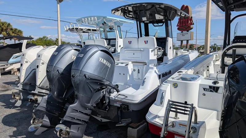 Slide: The Image of 2025 Wellcraft 243 Fisherman boat with Yamaha engines displayed at a dealership. - 4