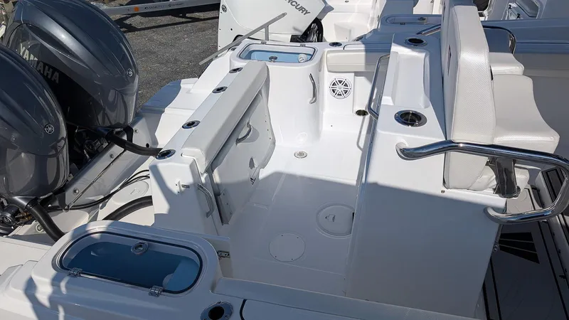 Slide: The Image of 2025 Wellcraft 243 Fisherman boat interior with dual engines and seating area. - 7