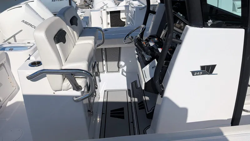 Slide: The Image of 2025 Wellcraft 243 Fisherman boat interior with seating and steering console. - 8