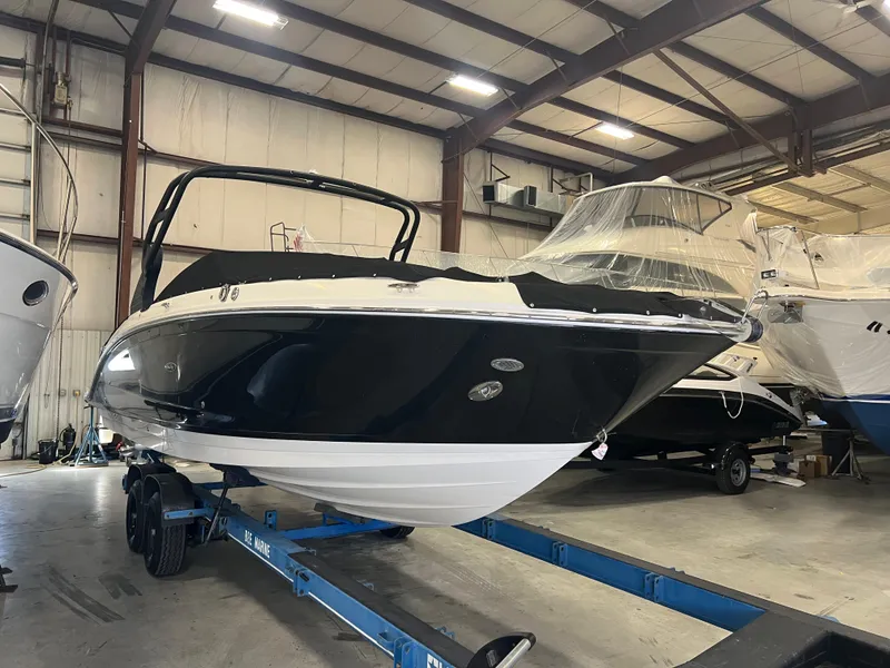 Slide: The Image of 2020 Sea Ray SDX 290 Outboard boat in indoor storage on a trailer. - 2