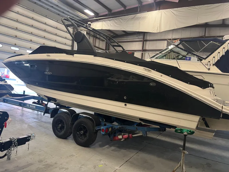 Slide: The Image of 2020 Sea Ray SDX 290 Outboard boat in indoor storage on a trailer. - 3