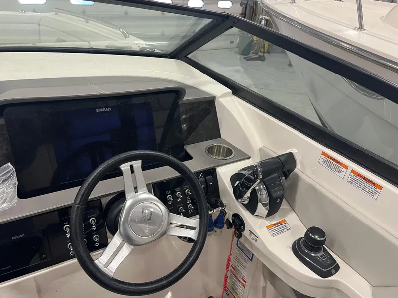 Slide: The Image of 2020 Sea Ray SDX 290 Outboard helm with steering wheel and control panel. - 33