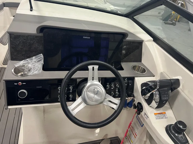 Slide: The Image of 2020 Sea Ray SDX 290 Outboard helm with steering wheel and control panel. - 6