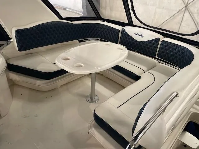 Slide: The Image of 2005 Sea Ray 420 Sedan Bridge interior with cushioned seating and table. - 10