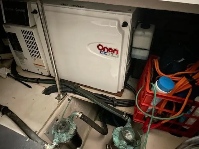 Slide: The Image of Engine room of 2005 Sea Ray 420 Sedan Bridge with Onan generator and equipment. - 12