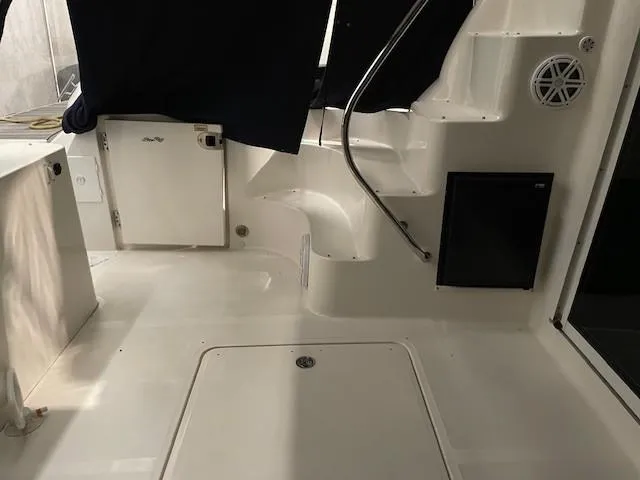 Slide: The Image of 2005 Sea Ray 420 Sedan Bridge interior with stairs and storage compartments. - 14