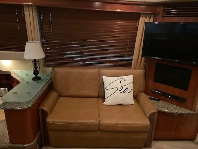 Slide: The Image of Interior of 2005 Sea Ray 420 Sedan Bridge with leather sofa and nautical decor. - 17