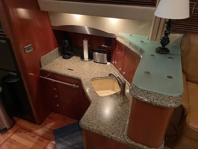 Slide: The Image of Luxurious kitchen area in 2005 Sea Ray 420 Sedan Bridge yacht with granite countertops. - 21