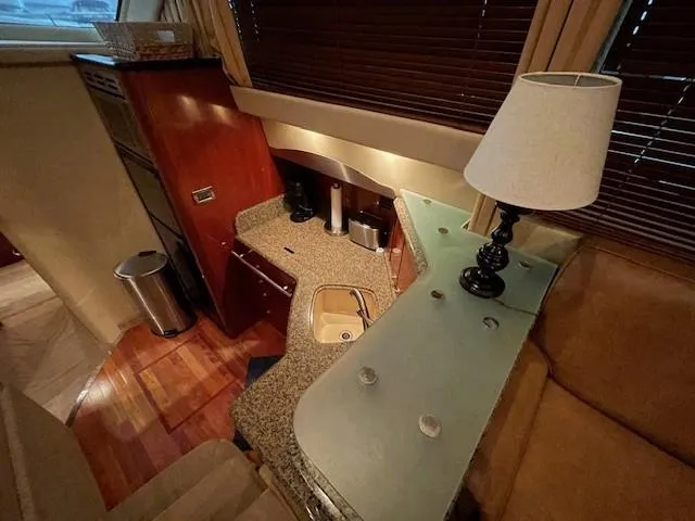 Slide: The Image of Interior of 2005 Sea Ray 420 Sedan Bridge yacht with kitchenette and lamp. - 23