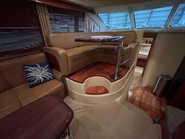 Slide: The Image of Interior of 2005 Sea Ray 420 Sedan Bridge yacht with elegant seating and table. - 24