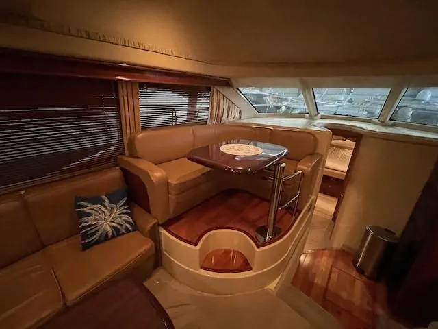 Slide: The Image of Interior of 2005 Sea Ray 420 Sedan Bridge with cozy seating and dining area. - 25