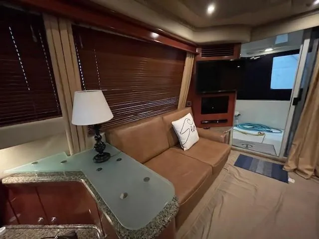 Slide: The Image of Interior of 2005 Sea Ray 420 Sedan Bridge with sofa, lamp, and TV. - 27