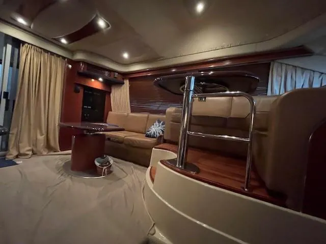 Slide: The Image of Luxurious interior of a 2005 Sea Ray 420 Sedan Bridge yacht with elegant seating and lighting. - 28