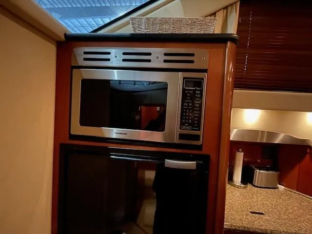 Slide: The Image of 2005 Sea Ray 420 Sedan Bridge kitchen with microwave and countertop. - 30