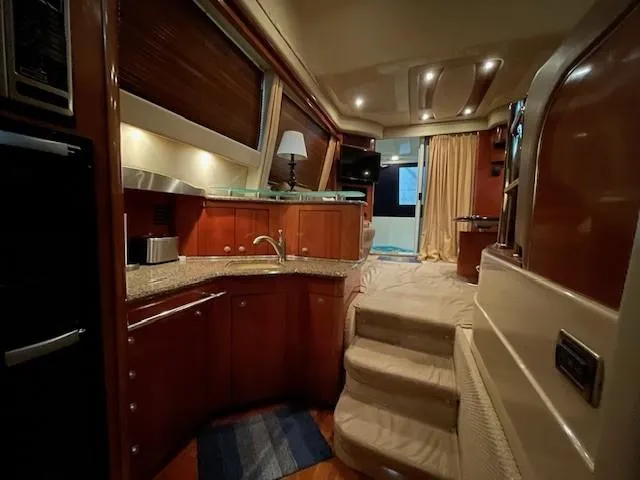 Slide: The Image of Luxurious interior of 2005 Sea Ray 420 Sedan Bridge yacht with elegant wood finishes. - 31