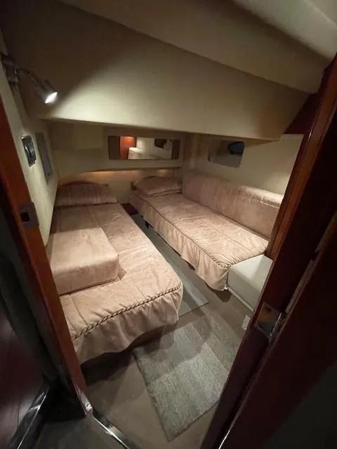 Slide: The Image of Interior cabin of 2005 Sea Ray 420 Sedan Bridge with twin beds and cozy lighting. - 34