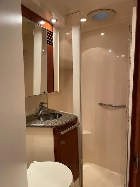 Slide: The Image of 2005 Sea Ray 420 Sedan Bridge bathroom with sink, mirror, and shower. - 38