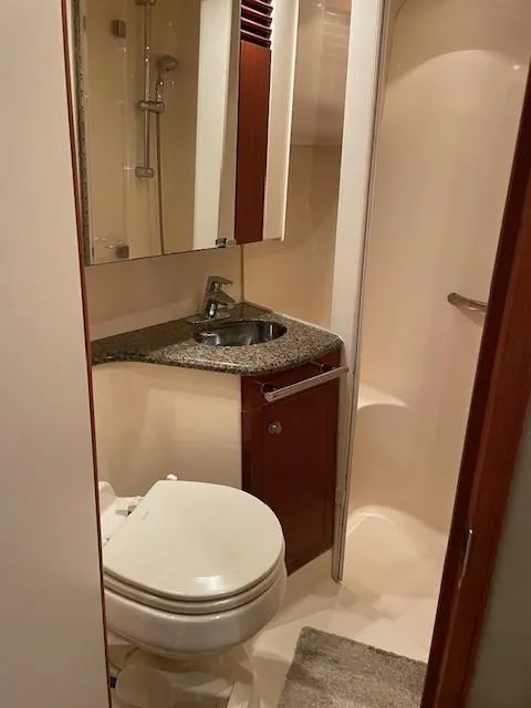 Slide: The Image of 2005 Sea Ray 420 Sedan Bridge bathroom with sink, toilet, and shower. - 39