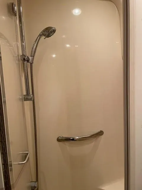 Slide: The Image of Shower area in 2005 Sea Ray 420 Sedan Bridge yacht, featuring handheld showerhead and grab bar. - 42