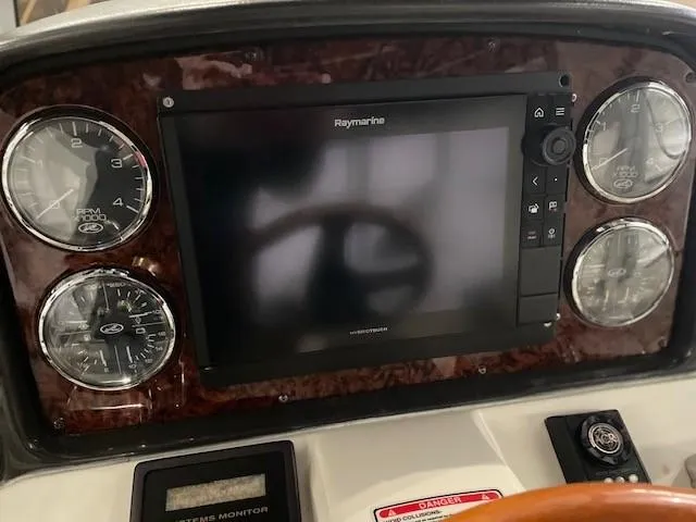 Slide: The Image of Dashboard of 2005 Sea Ray 420 Sedan Bridge with Raymarine display and gauges. - 45