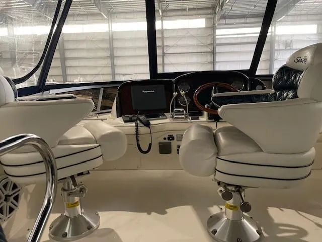 Slide: The Image of Interior cockpit of 2005 Sea Ray 420 Sedan Bridge with dual captain chairs. - 6