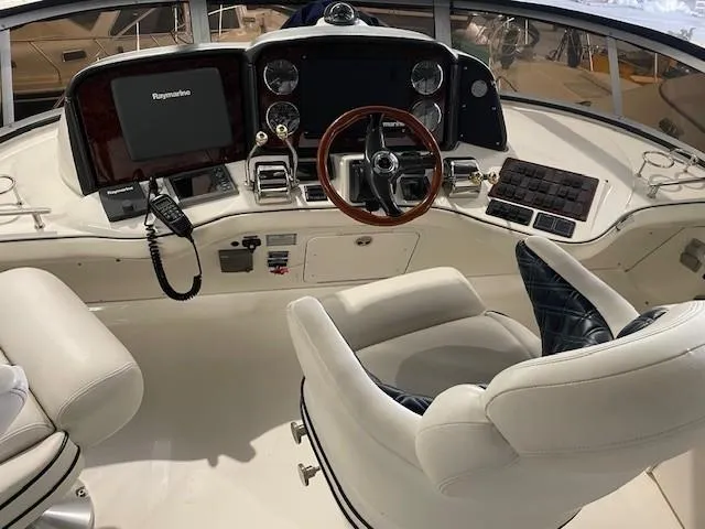 Slide: The Image of Helm of 2005 Sea Ray 420 Sedan Bridge with modern navigation equipment and plush seating. - 8