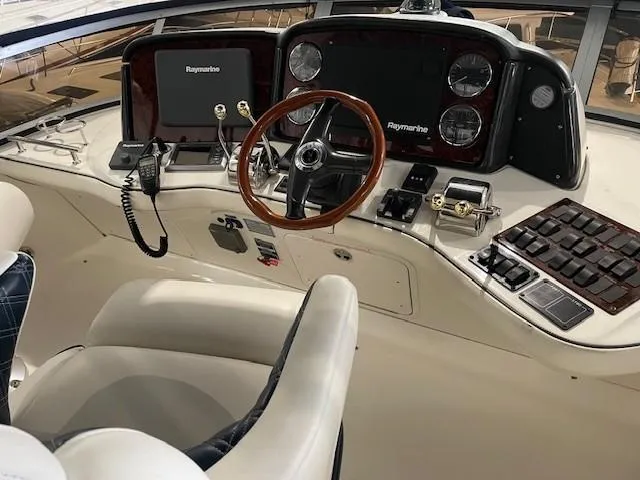 Slide: The Image of Helm of 2005 Sea Ray 420 Sedan Bridge with Raymarine electronics and wood-accented steering wheel. - 9