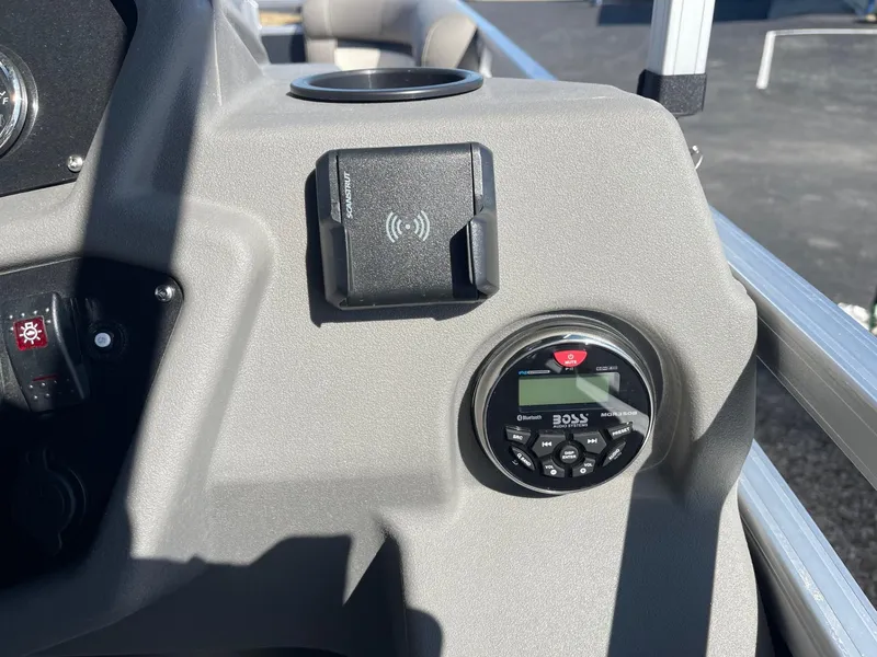 Slide: The Image of Control panel of 2025 Armada Saphir 23CR boat with audio system and wireless charger. - 23