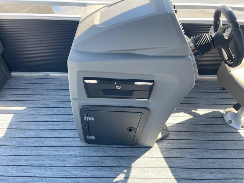 Slide: The Image of Control console of 2025 Armada Saphir 23CR boat with steering wheel and storage compartments. - 24